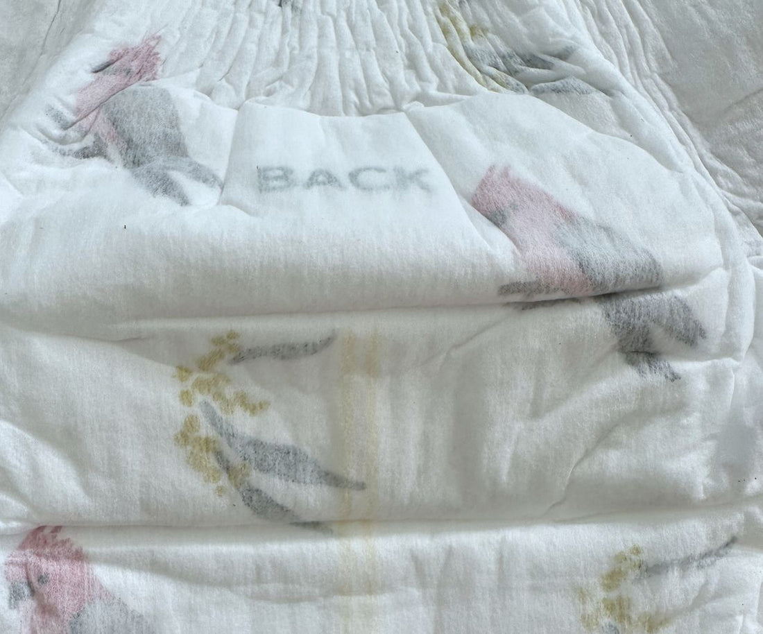 BACK printed on the rear half of a Little Puggles nappy, beside the gathered back edge