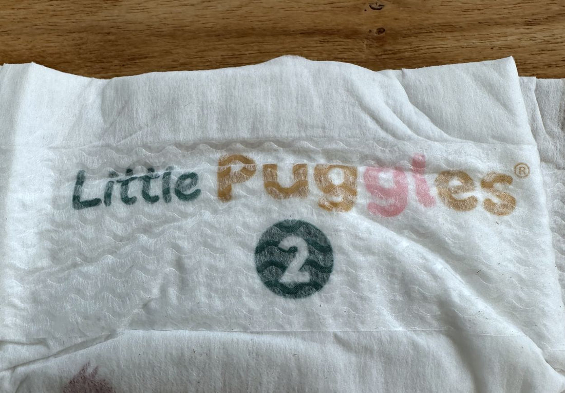 The wide front fastening panel running across the front of a nappy, with the printed backsheet either side of it where the hooks have nothing to catch