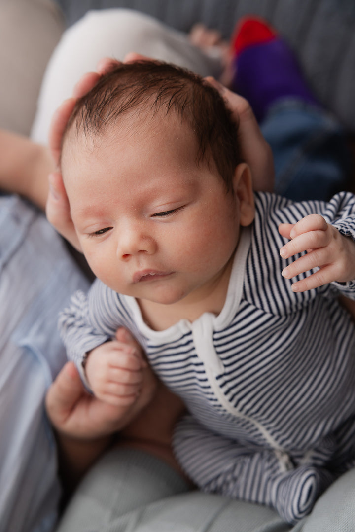 A mother holding her newborn, portrait