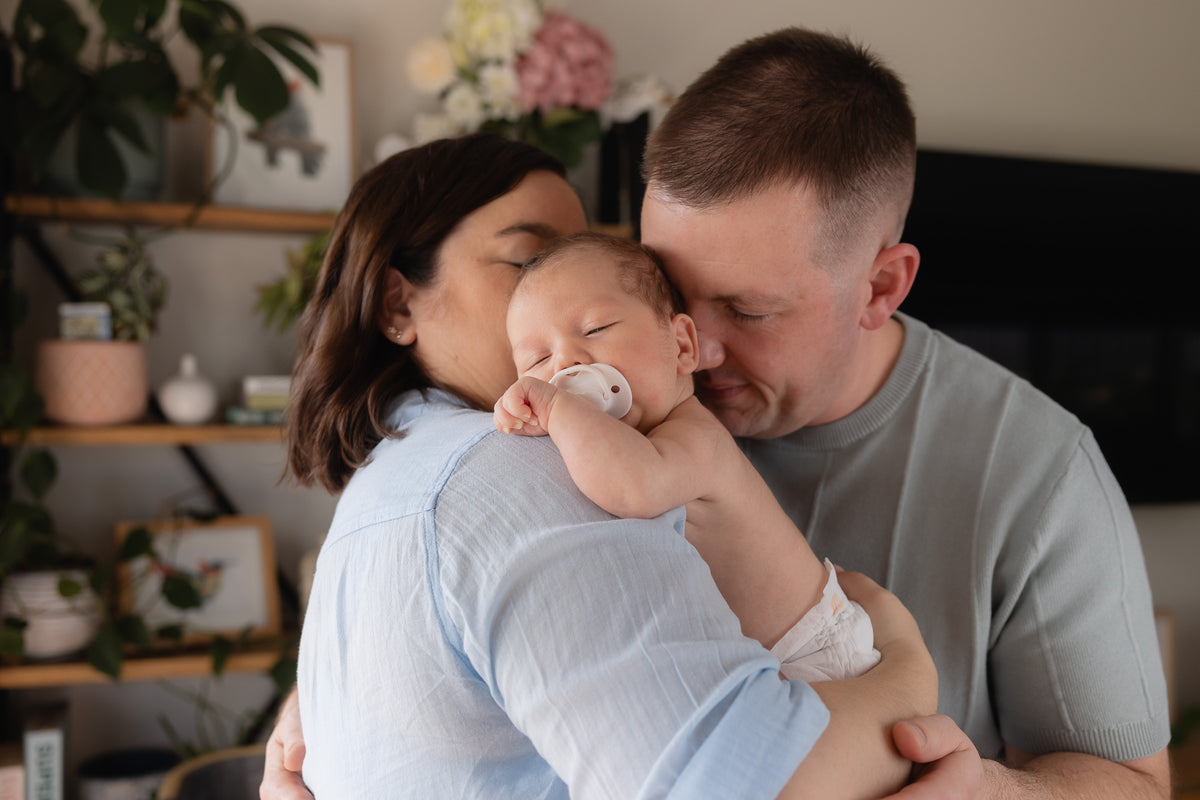Little Puggles founders Emma and Marcus Hando holding their newborn son Louis